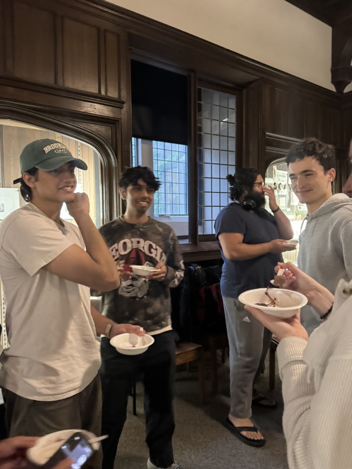 Members chatting over dessert at a social
